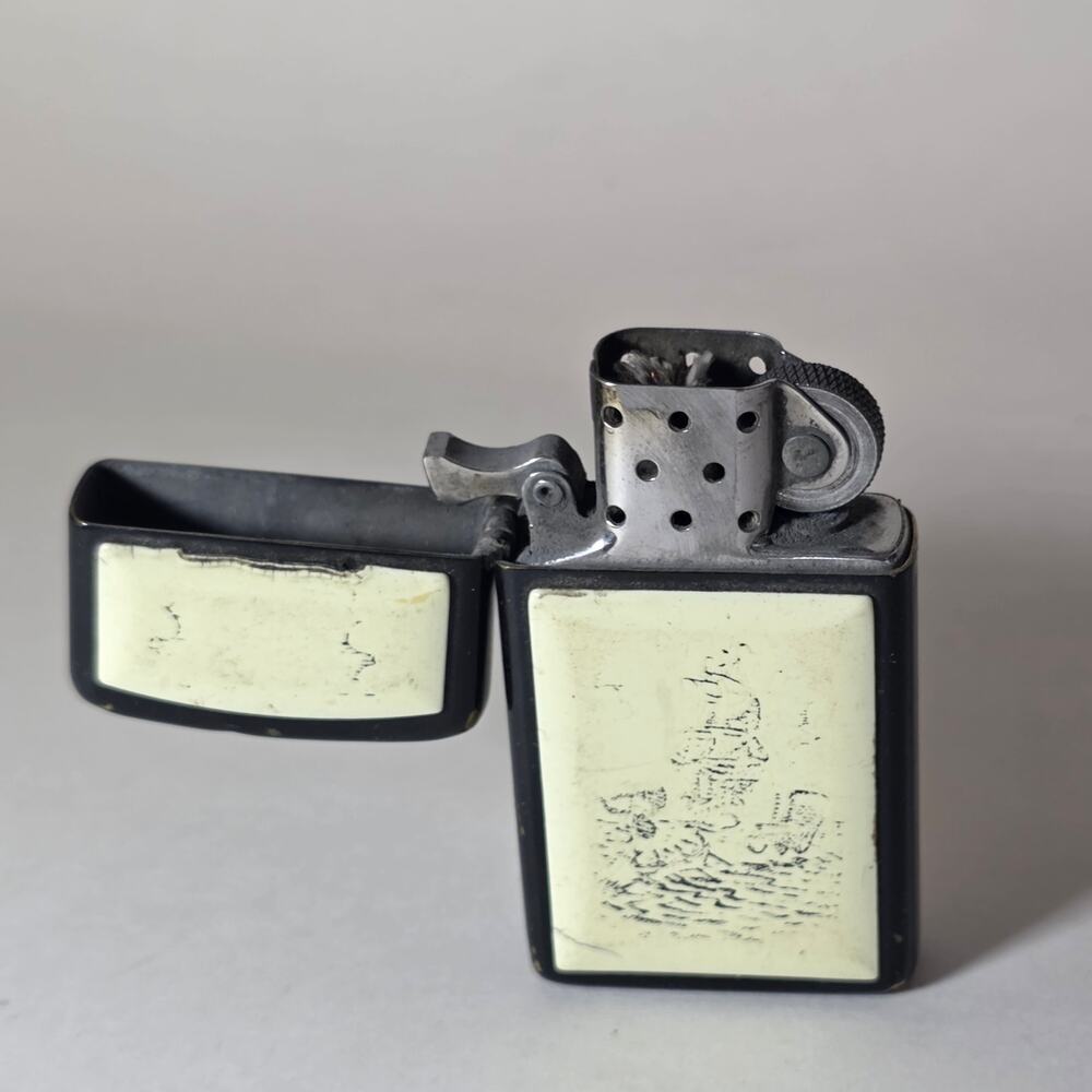 Vintage Zippo scrimshaw-style lighter with ship and lighthouse design.
